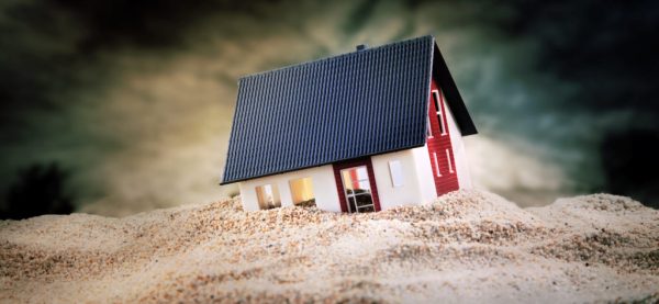 Miniature of house standing in sand 10 Foundation Maintenance Tips